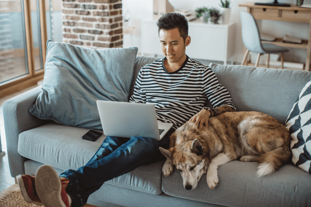 Man sitting on couch with dog